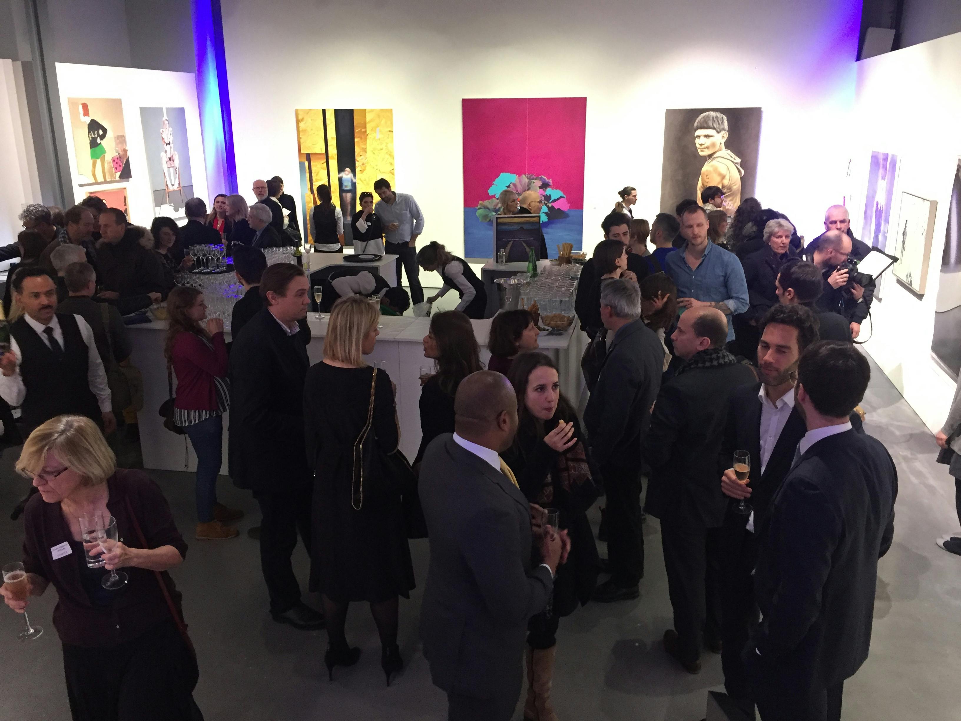 Vibrant networking event in East Gallery with contemporary art backdrop and engaged attendees.