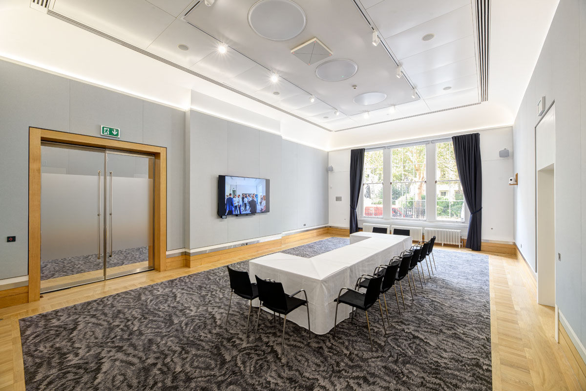 Sir Kirby Laing in a modern meeting room, ideal for corporate events and workshops. - Banner