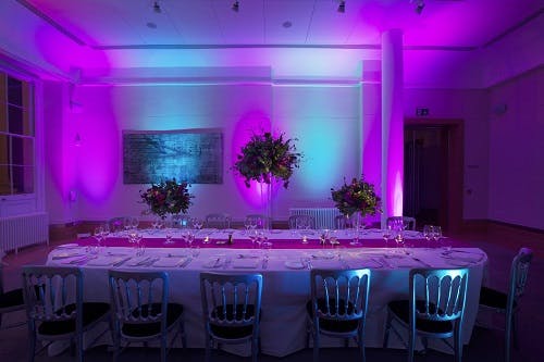 Elegant banquet table with floral centerpieces in Prince Philip House for upscale events.