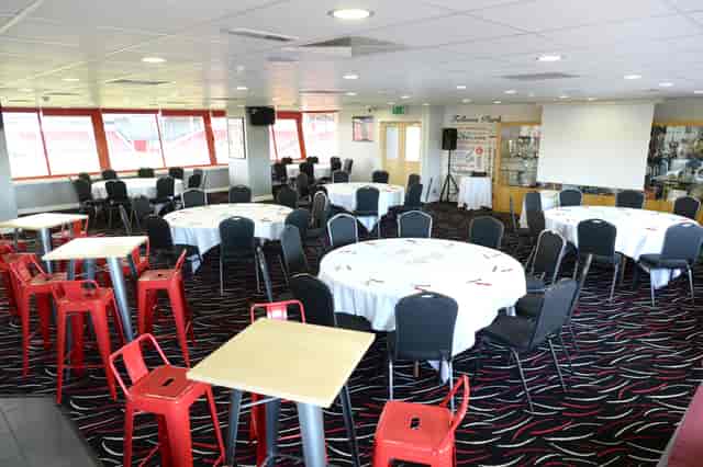 1888 Lounge at Walsall FC, elegant meeting space with round tables for events.