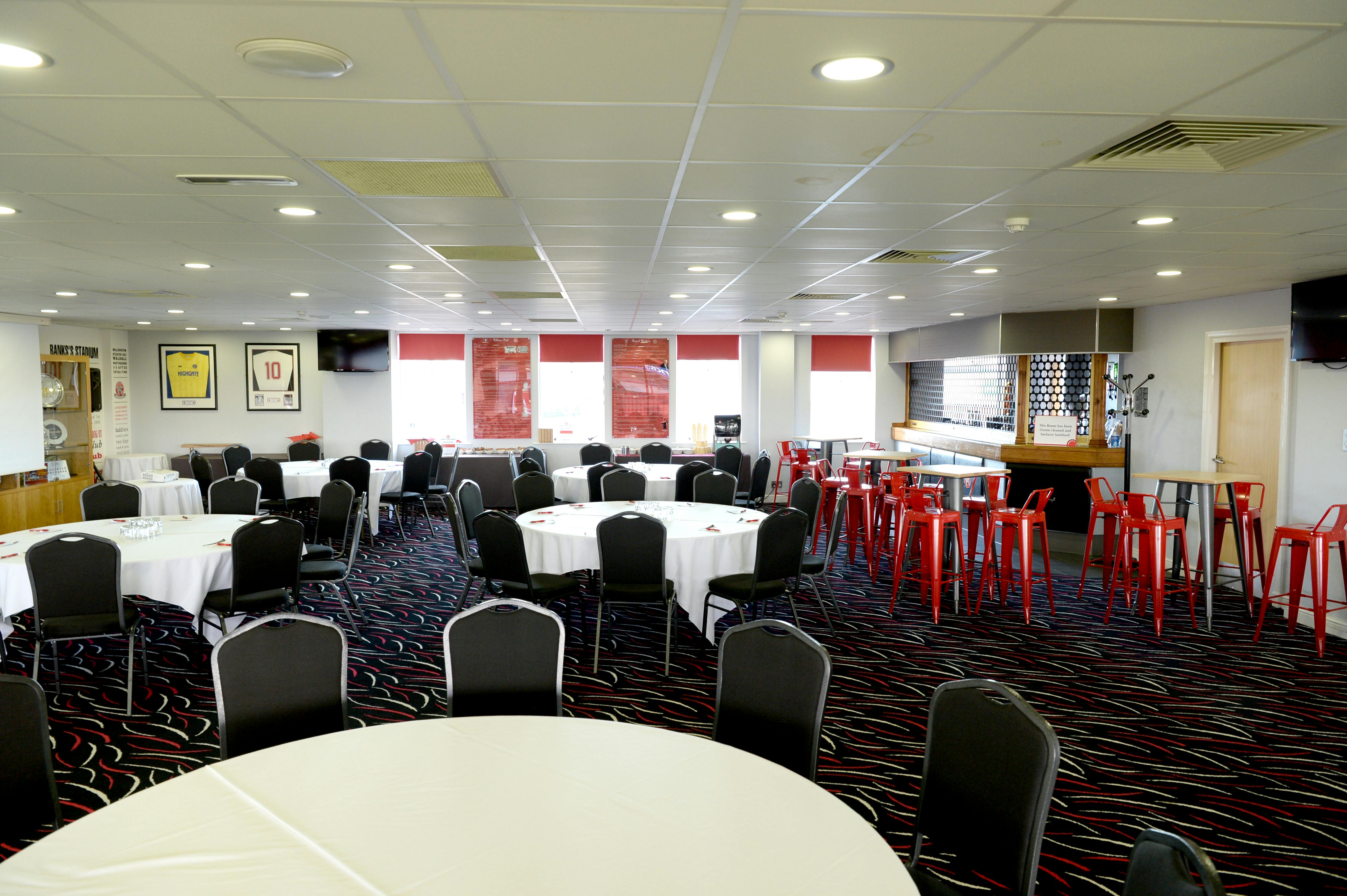 1888 Lounge at Walsall FC, elegant meeting space with round tables for events.