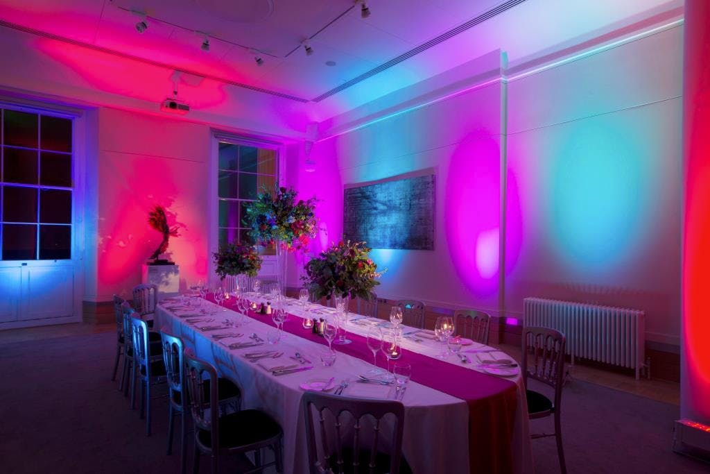 David Sainsbury at an elegant gala dinner in a beautifully lit dining space.
