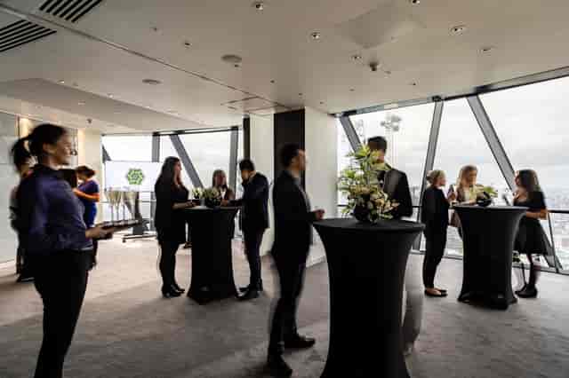 "Networking event at Searcys Level 38 in the Gherkin with floral decor and city views."