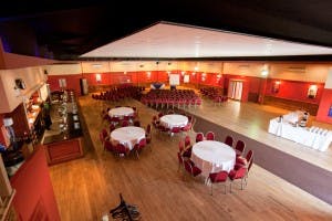 Spacious event venue with round tables, ideal for banquets and conferences at The Dray.