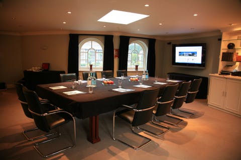 Chewton Glen Hotel meeting room with large table, ideal for corporate events and presentations.