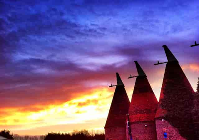 The Roundels at Hop Farm with sunset backdrop, perfect for outdoor events and receptions.