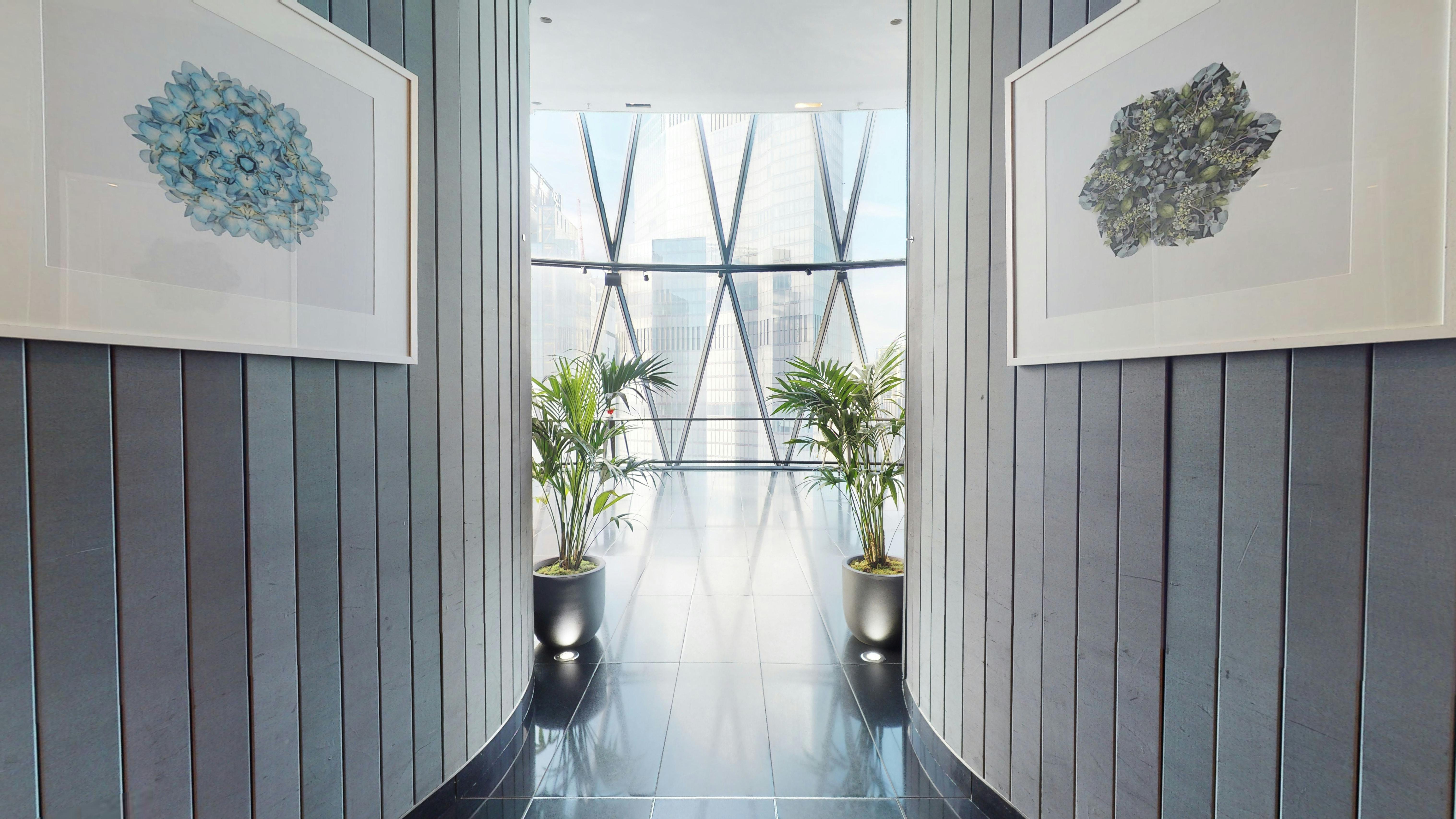"Modern corridor at Searcys Gherkin for networking events with natural light and art."