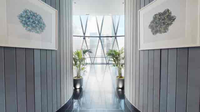 "Modern corridor at Searcys Gherkin for networking events with natural light and art."