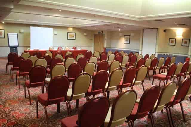 Southan Suite at Westmead Hotel, ready for a conference with rows of chairs and presentation screen.