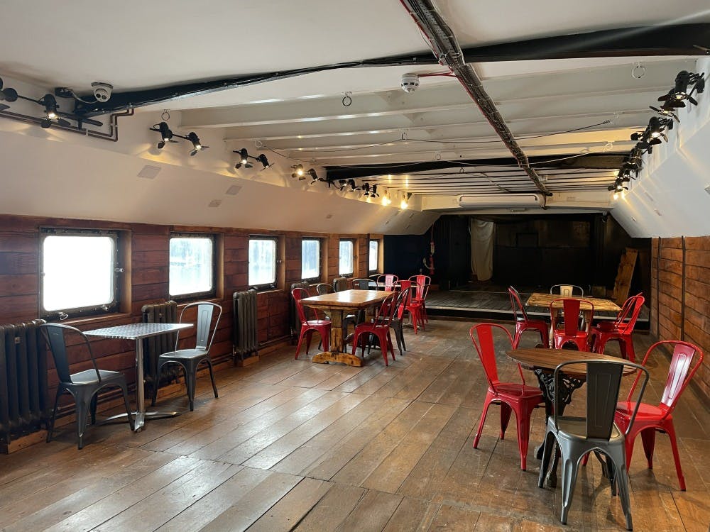 Lower Deck at Battersea Barge: rustic event space with wooden walls, ideal for meetings and networking.