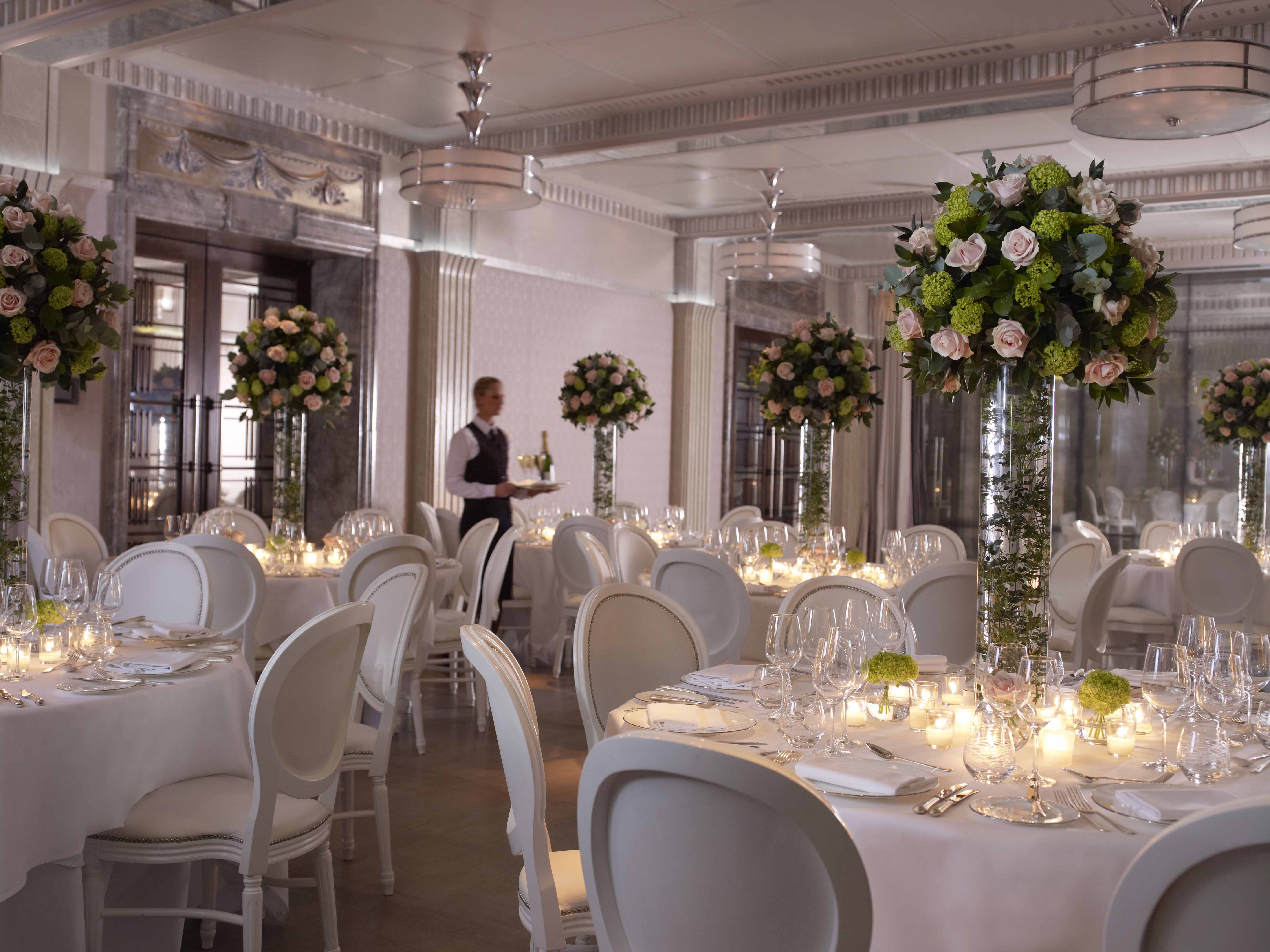 Elegant Mayfair Room banquet hall with floral centerpieces, perfect for weddings and corporate events. - Banner