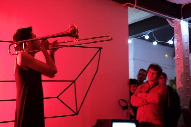 Live performance at Centrala Gallery with trombone, vibrant lighting, engaging entertainment.