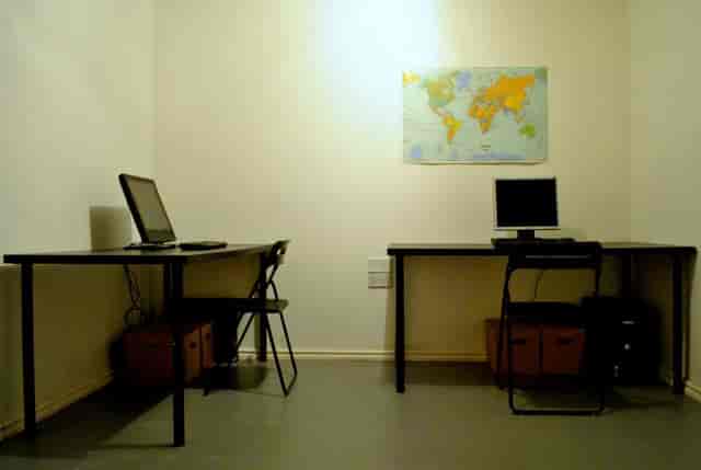 Minimalist meeting space with desks, ideal for team collaborations and virtual meetings.