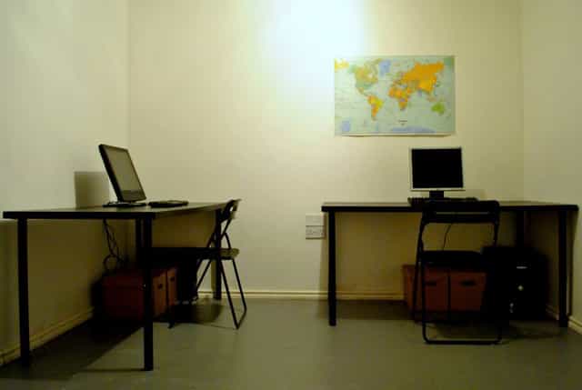 Minimalist meeting space with desks, ideal for team collaborations and virtual meetings.