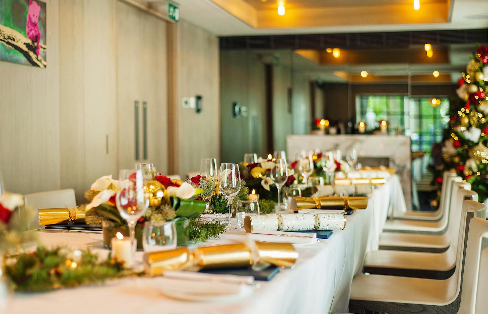 Elegant dining table with floral centerpieces for corporate Christmas parties.