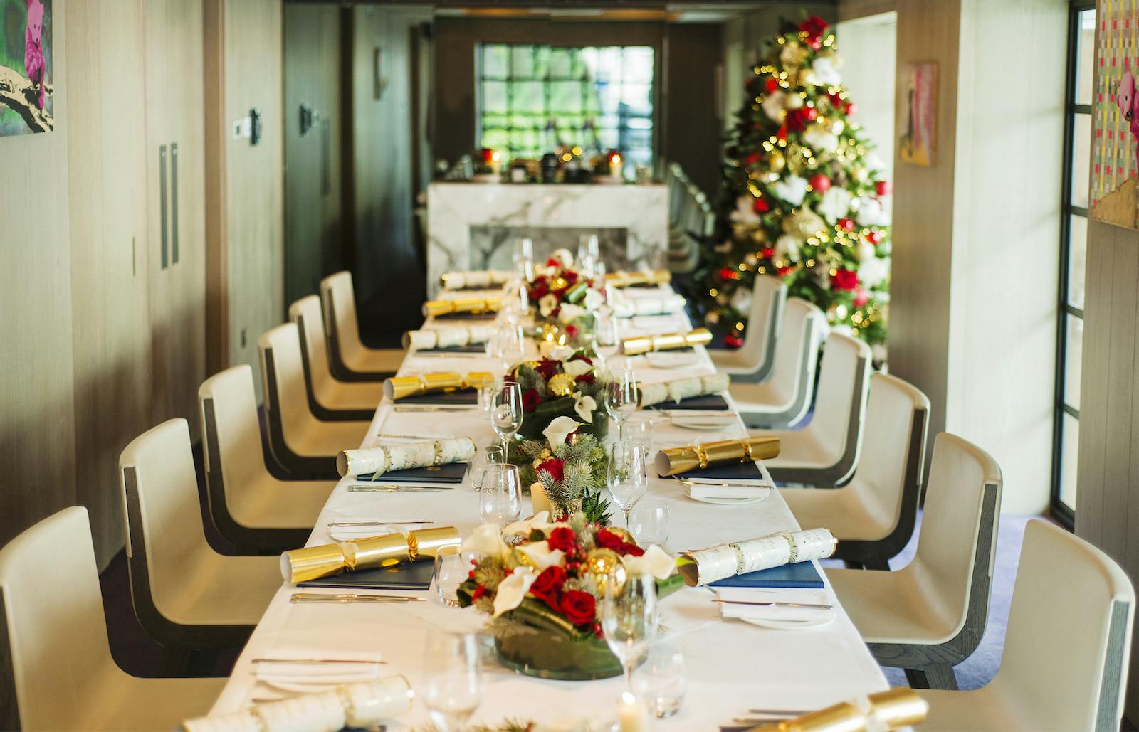 Elegant dining table with floral arrangements for festive corporate Christmas parties.