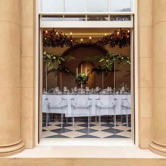 Elegant event space at Exclusive Use Manor House with modern table setting and floral decor.