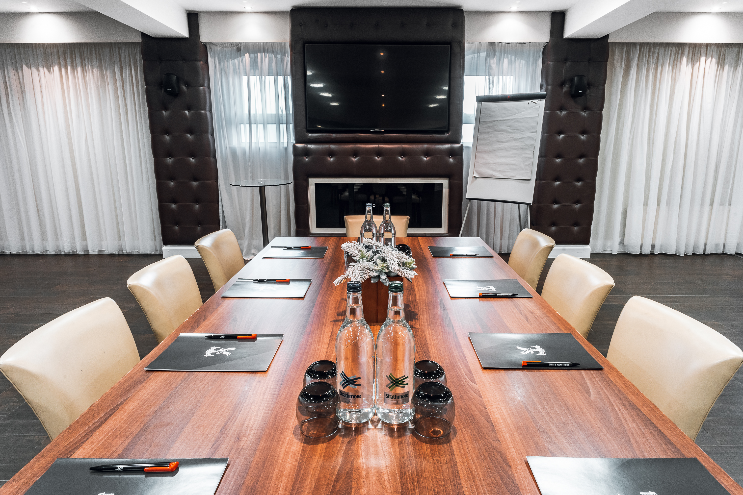 Boardroom at Selhurst Park Stadium, featuring a long wooden table for corporate meetings. - Banner