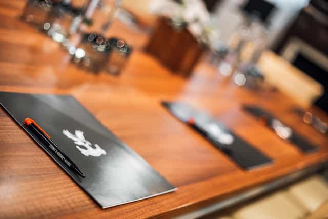 Boardroom at Selhurst Park Stadium with polished wooden table for meetings and brainstorming.