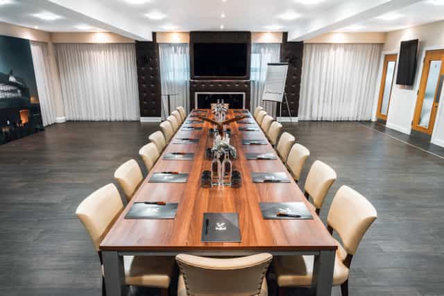 Boardroom at Selhurst Park Stadium with polished table, ideal for corporate meetings.