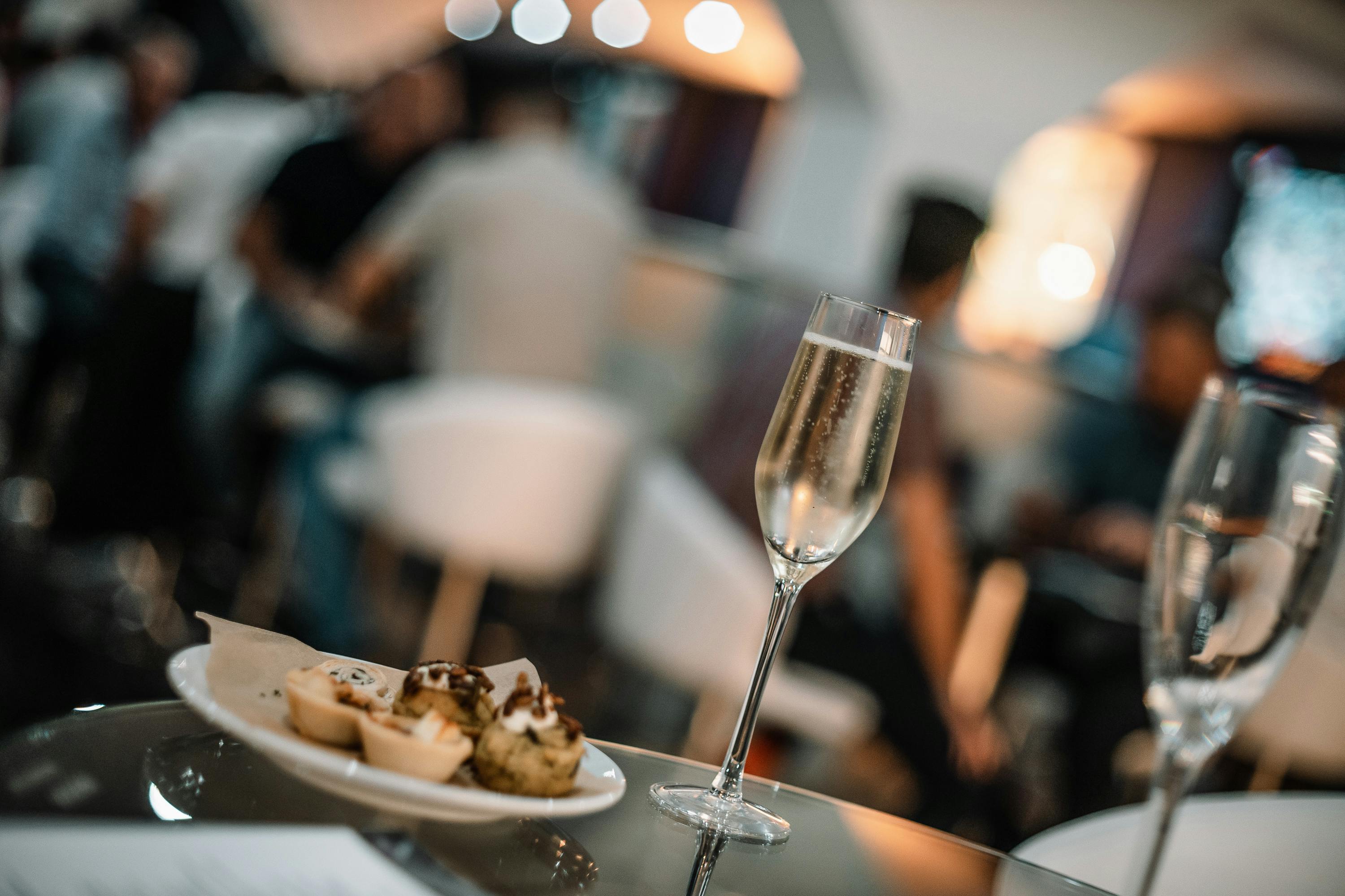 Elegant networking event at Crystal Palace with champagne and gourmet food.