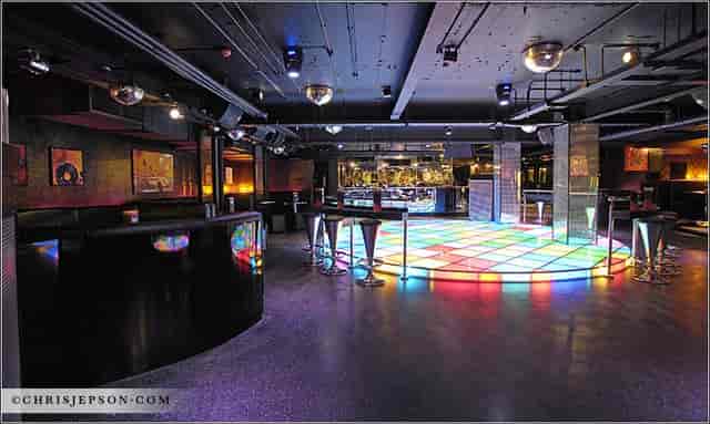 Vibrant dance floor at Groovy Wonderland in Loop Bar for nightlife events and celebrations.