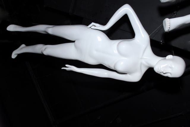 Sleek white mannequin in Piccadilly Institute for fashion and product displays.