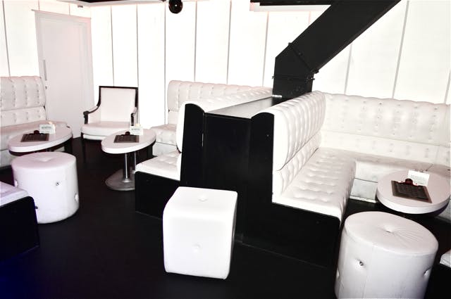Modern lounge at Clinic VIP, featuring white tufted seating for networking events.