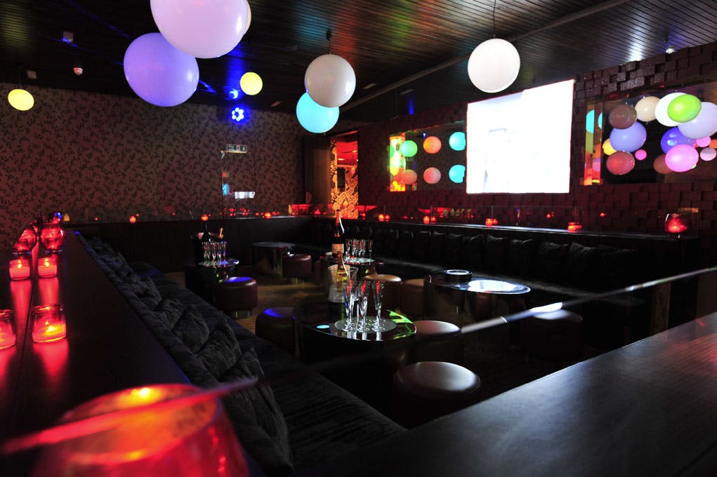 Vibrant event space with colorful lighting, ideal for parties and corporate functions.