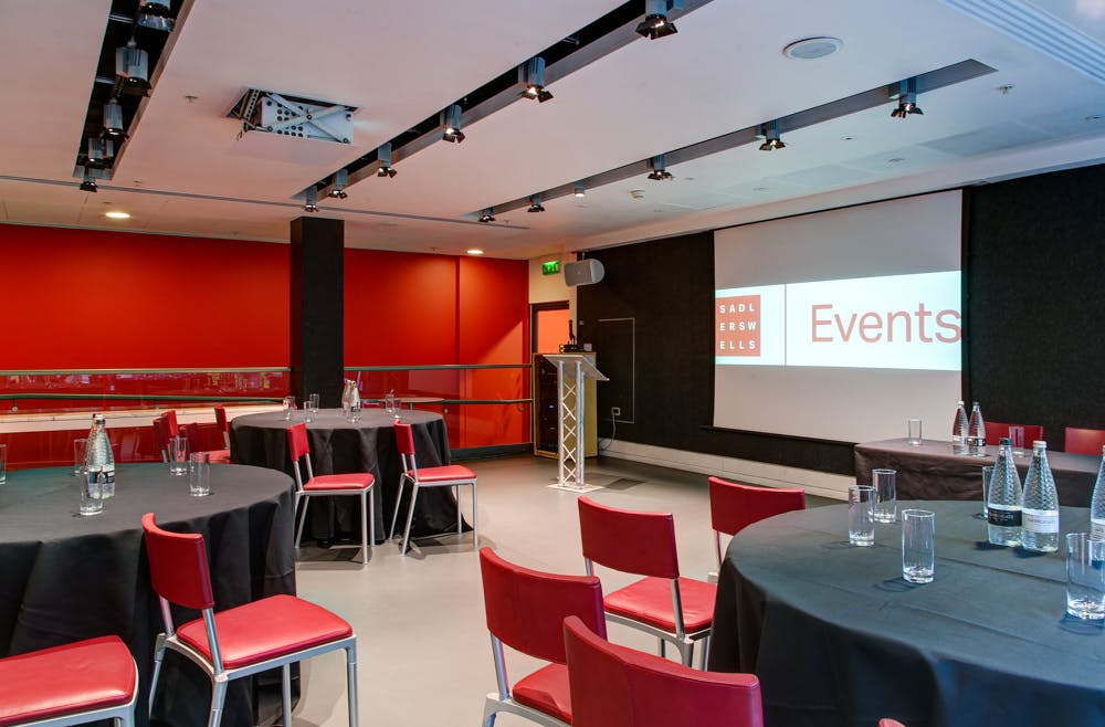 Dorfman Room at Sadler's Wells: professional meeting space with round tables and podium.
