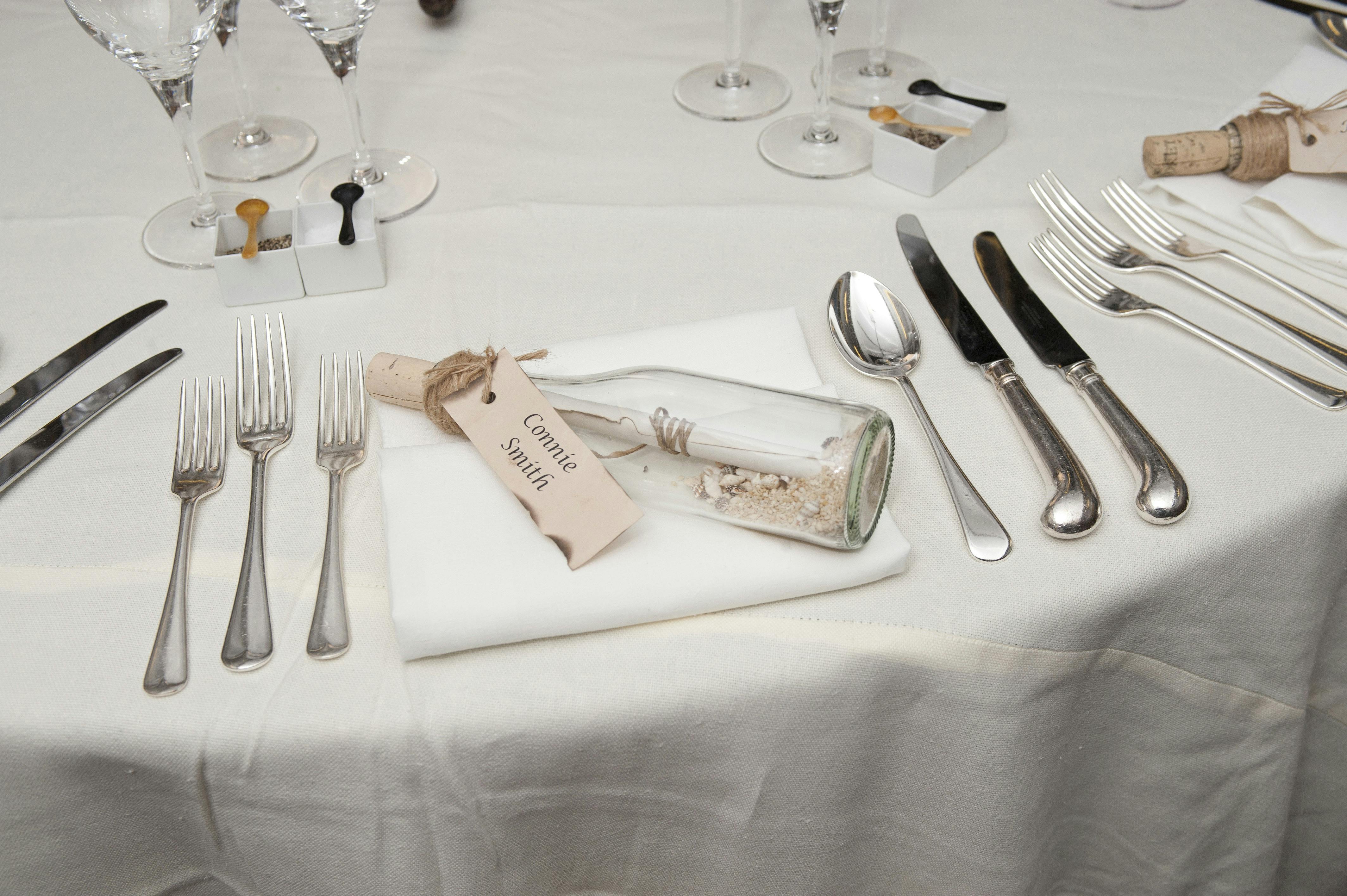 Elegant dining table on Cutty Sark with message in a bottle for upscale events.