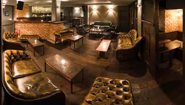Intimate lounge at Basement Sate for networking events with cozy seating and warm lighting.