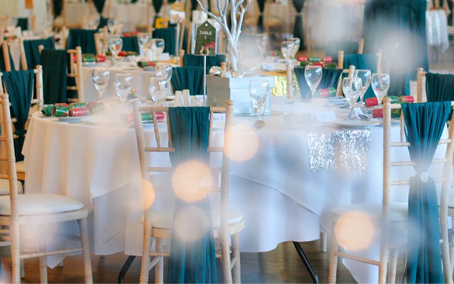 Elegant banquet space with teal accents, perfect for weddings or corporate events.