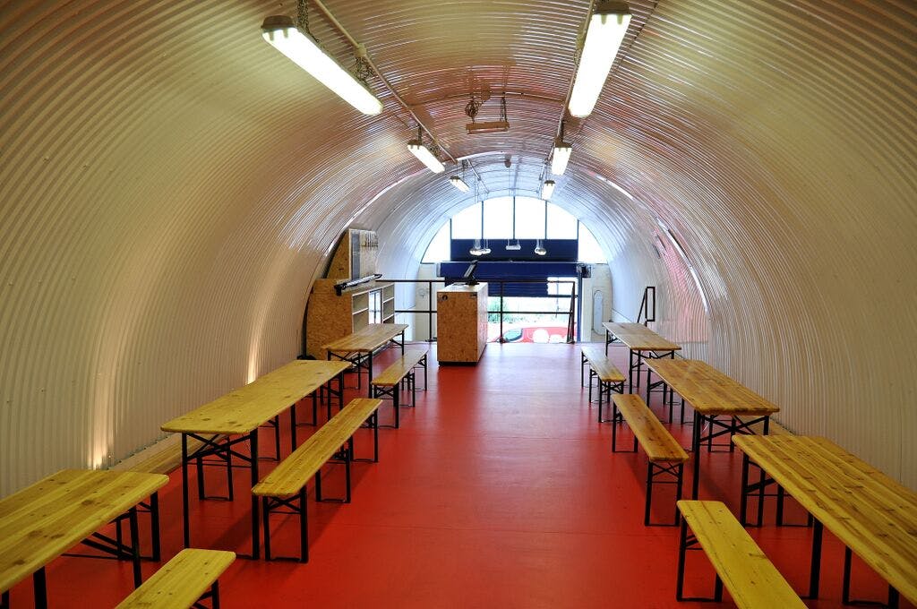 Mezzanine event space in The Bottle Shop SE1 with industrial design and bright red flooring.