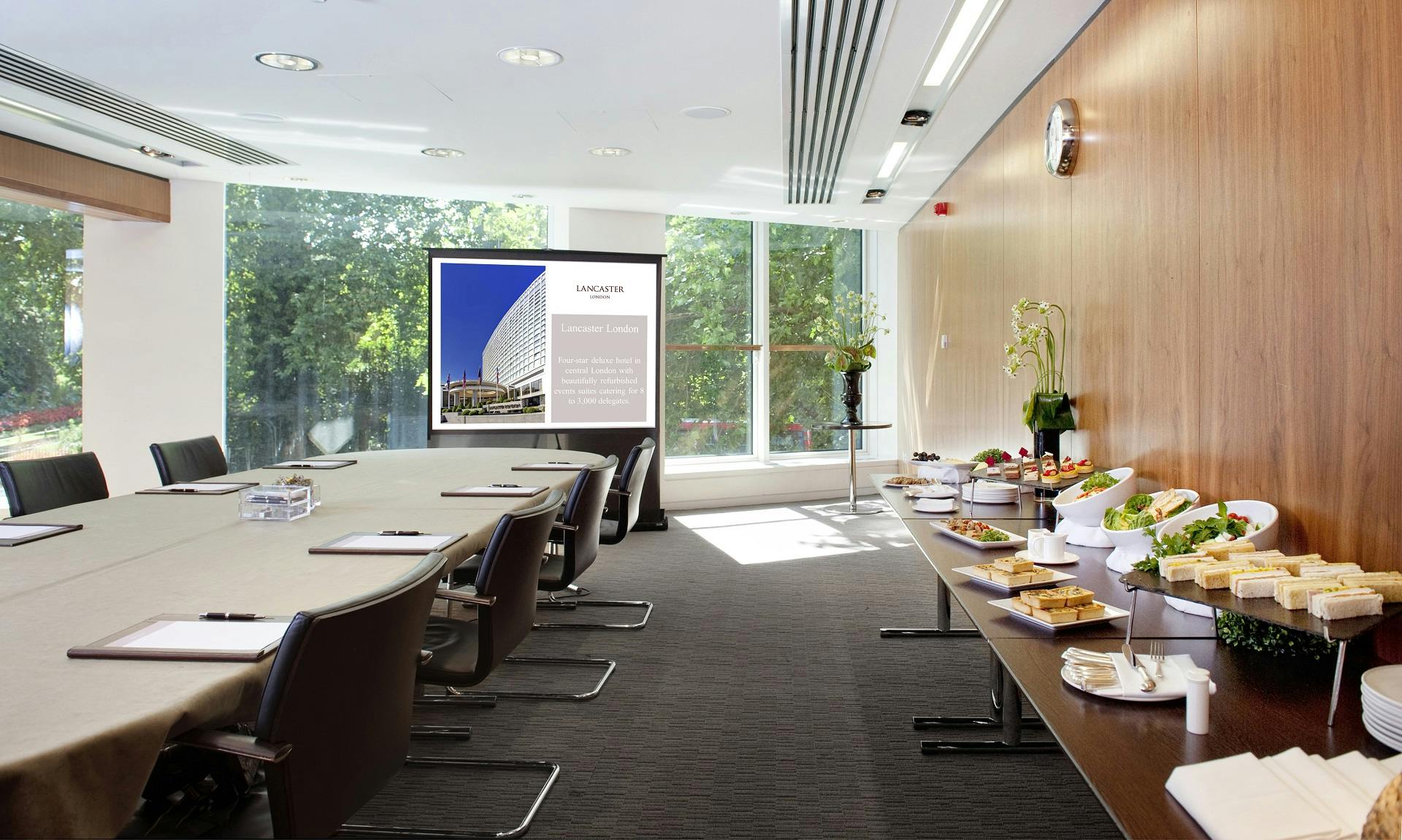 Modern meeting room with oval table for professional events in Royal Lancaster London.