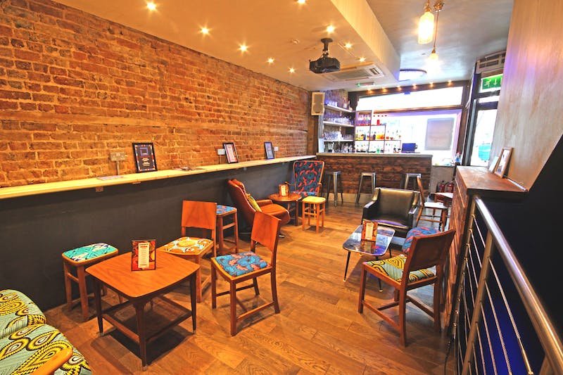 Cozy nightclub with exposed brick, perfect for informal meetings and small events.