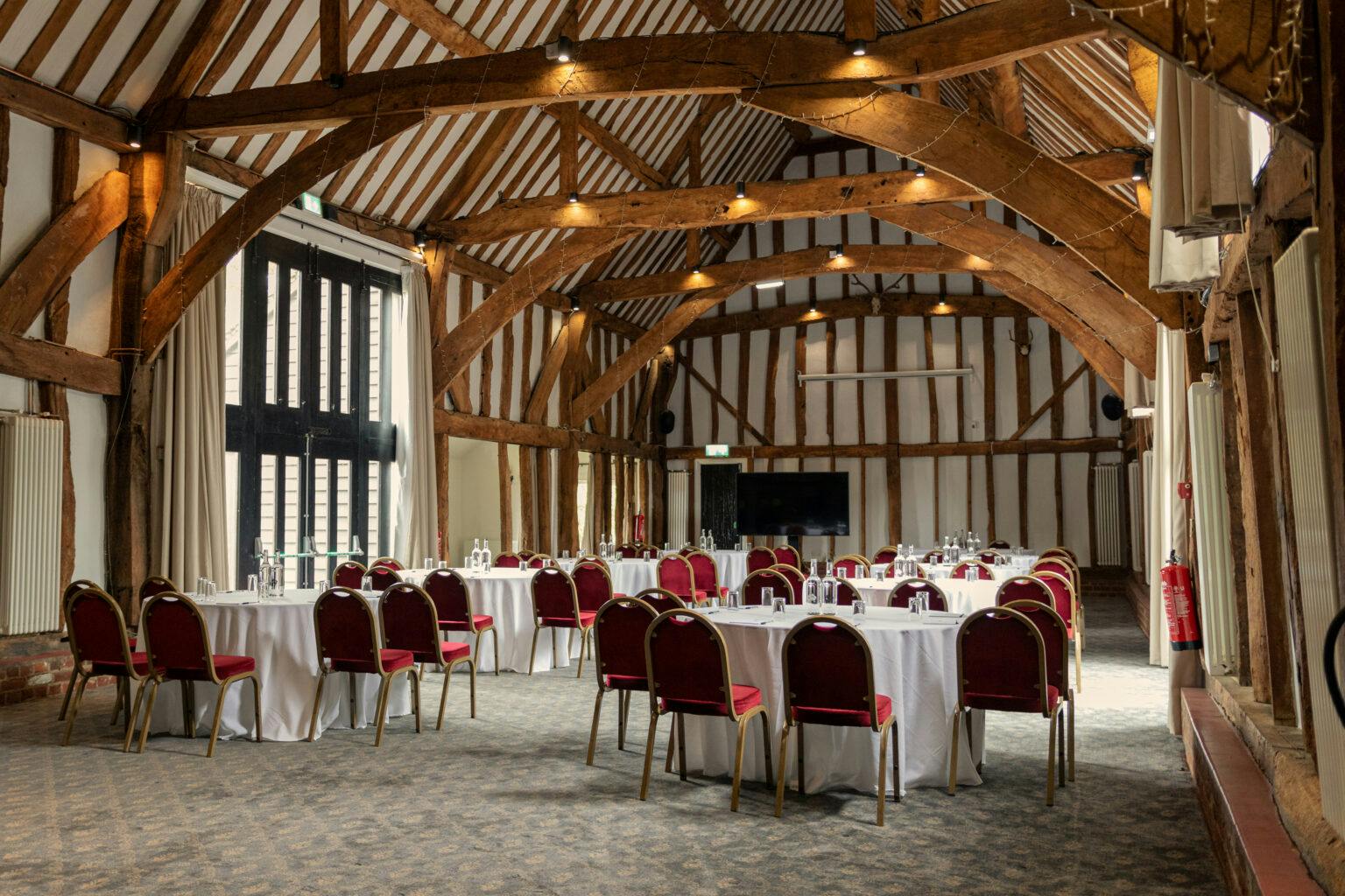 Manor Barn at Knebworth House: rustic event venue with elegant seating for celebrations.