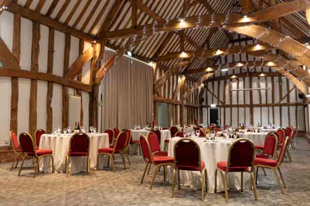 Manor Barn event space with round tables, ideal for weddings and corporate gatherings.