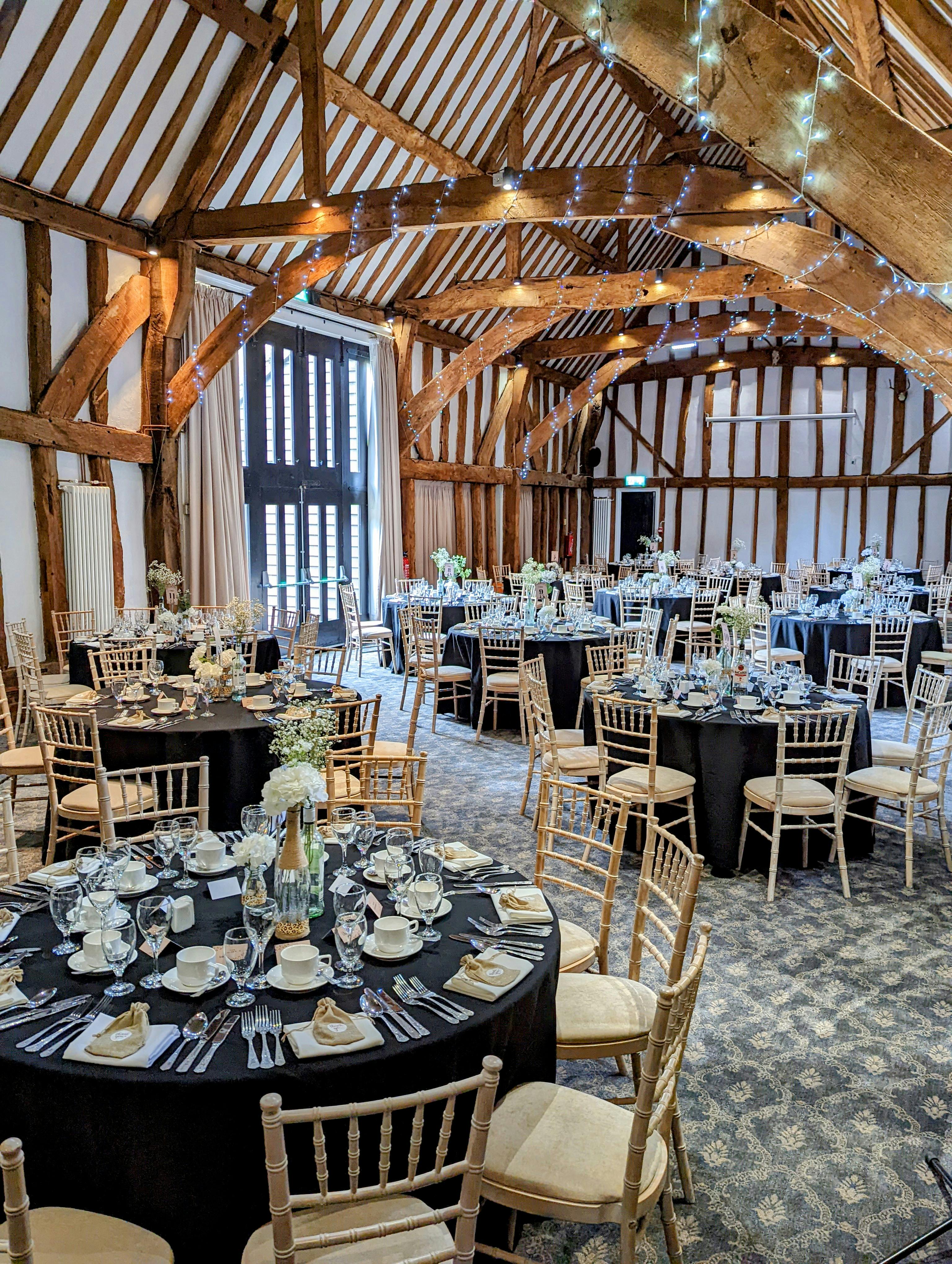 Elegant Manor Barn event space with round tables, ideal for formal dinners and receptions.