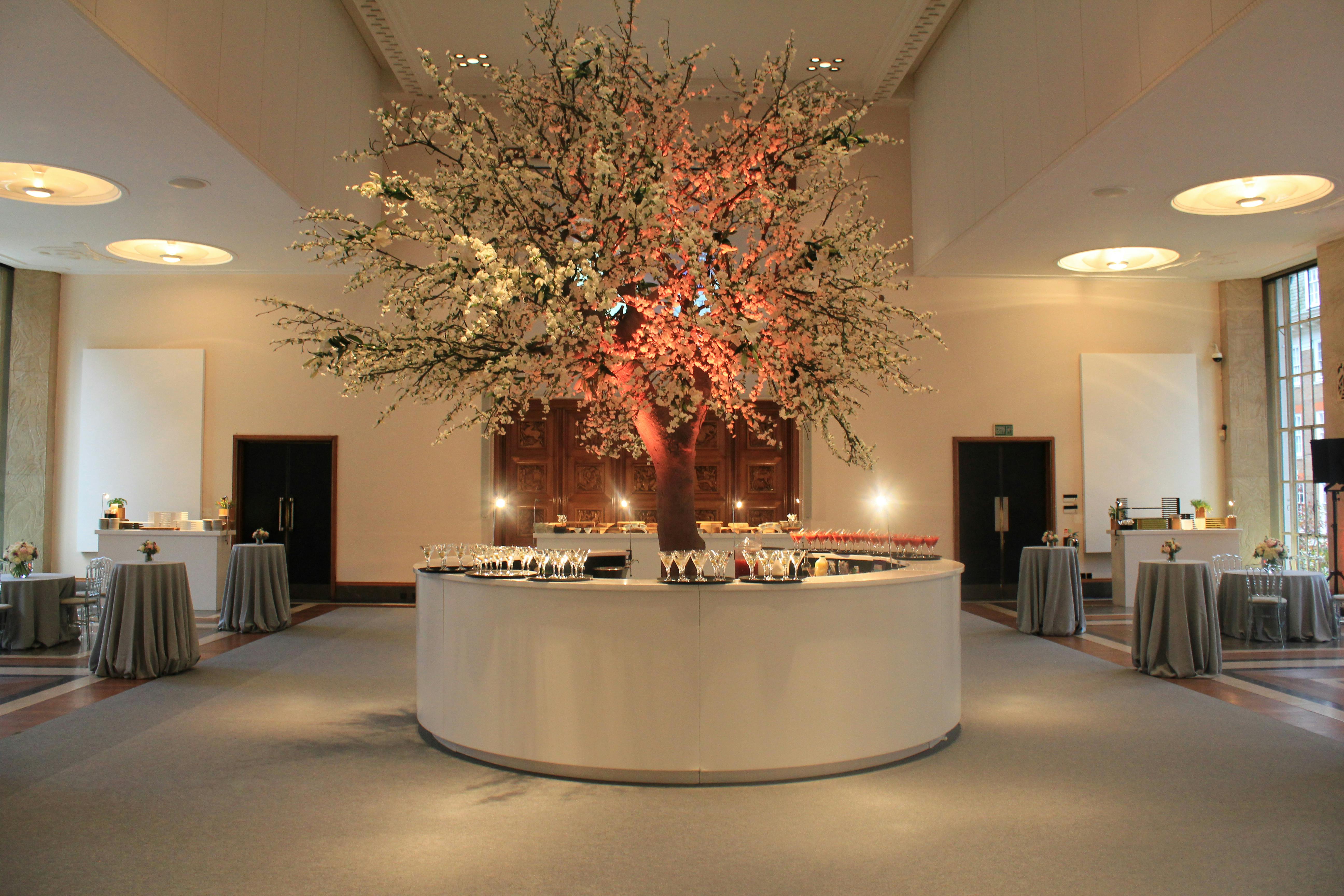 Florence Hall at RIBA with floral tree centerpiece, ideal for weddings and corporate events.