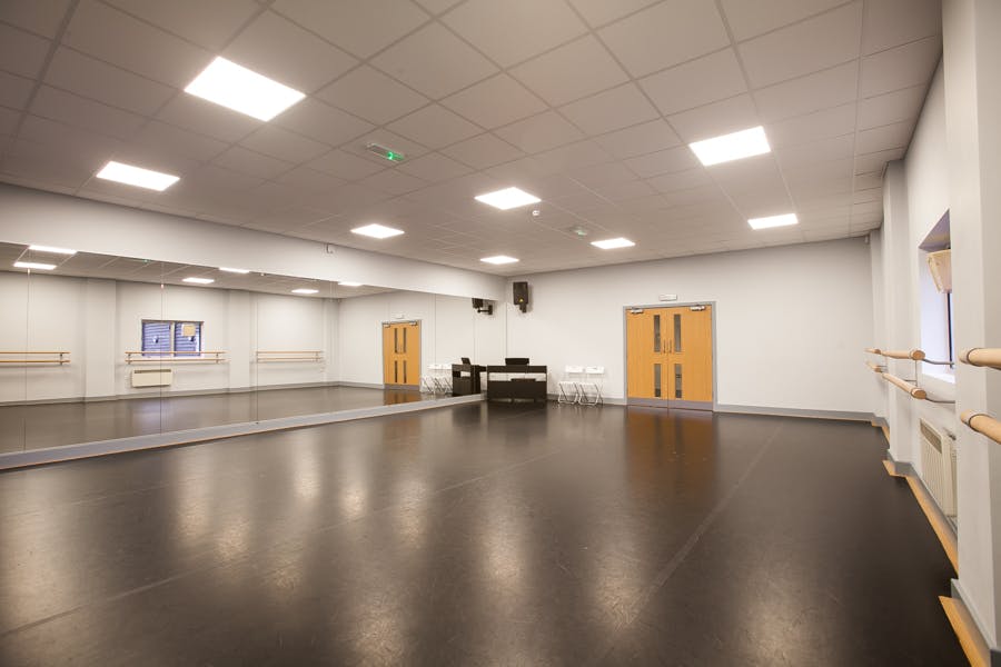 Versatile event space with mirrored walls for workshops and gatherings at Adagio School of Dance.