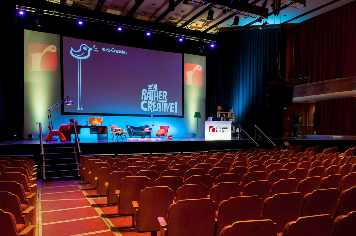 Brighton Dome Concert Hall stage with vibrant lighting for engaging presentations and events. - Banner