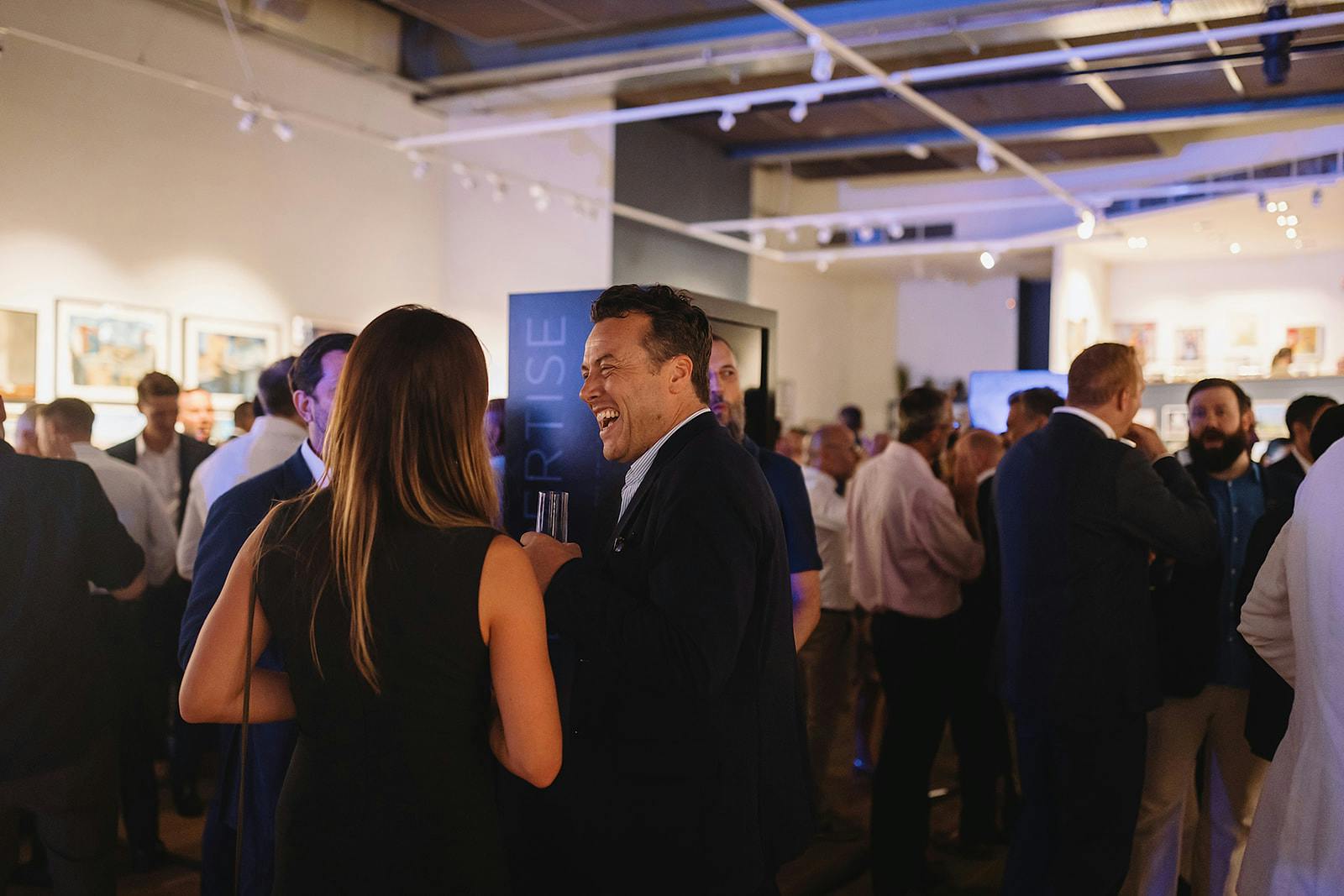 Vibrant networking event in West Gallery, Mall Galleries with engaging professionals and art.