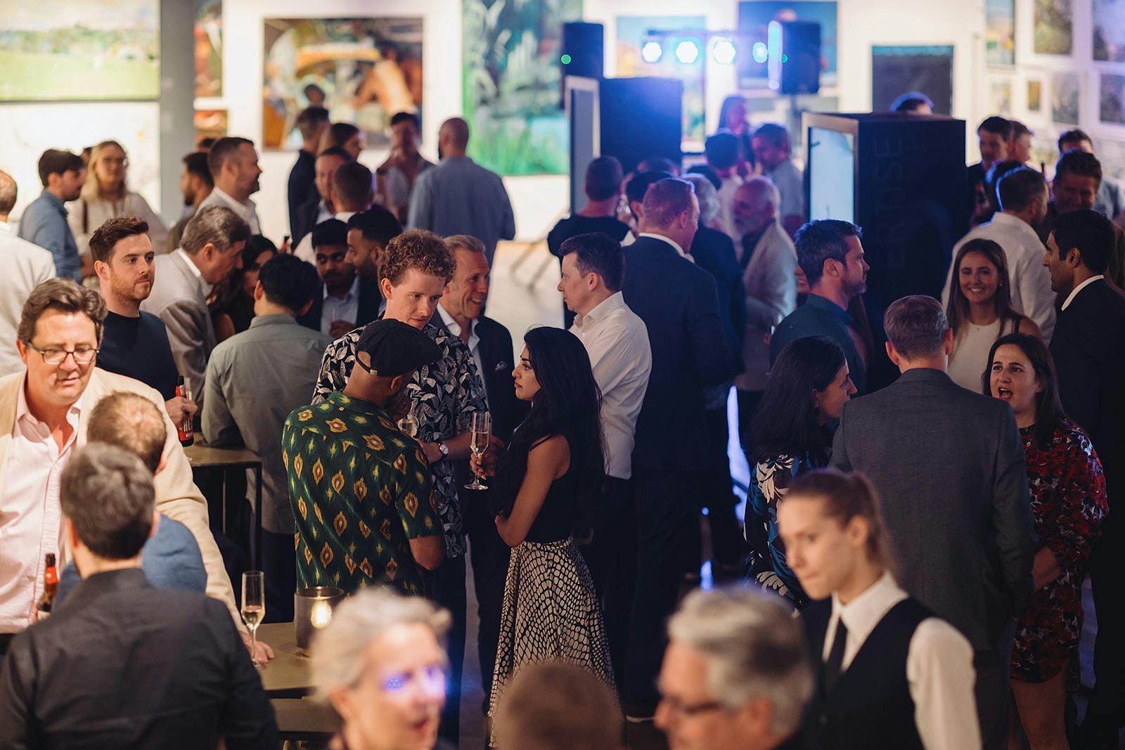 Vibrant networking event at West Gallery, Mall Galleries with engaged attendees.
