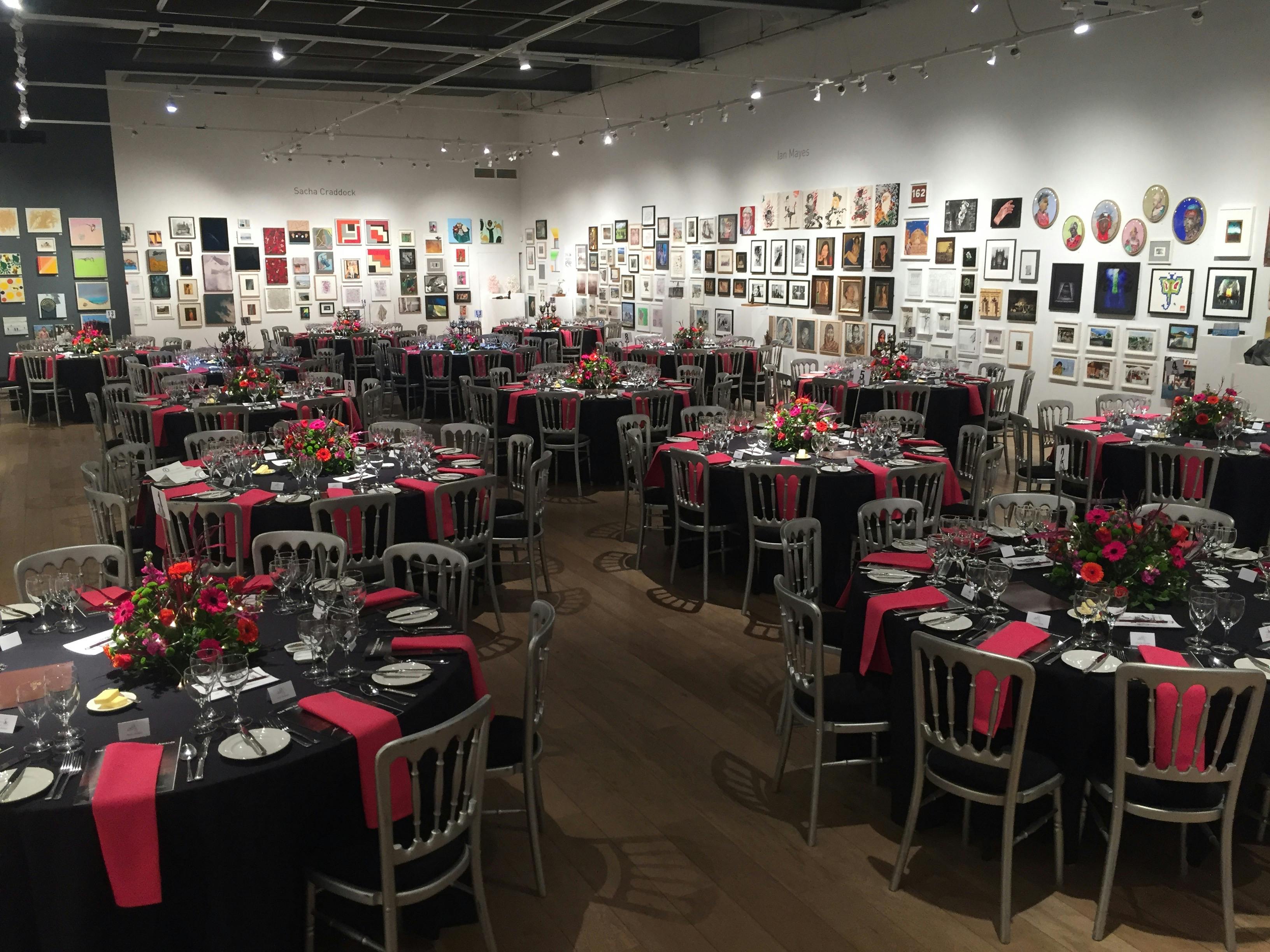 Elegant round tables with floral centerpieces in West Gallery, perfect for galas and fundraisers.