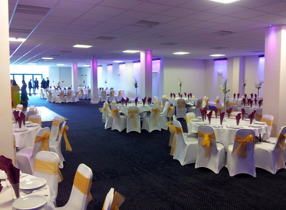 Elegant event space with round tables, perfect for weddings and corporate events.