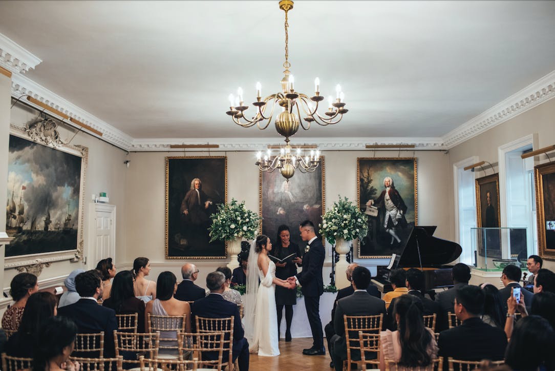 Elegant wedding ceremony in The Foundling Museum's Picture Gallery with classic artwork.