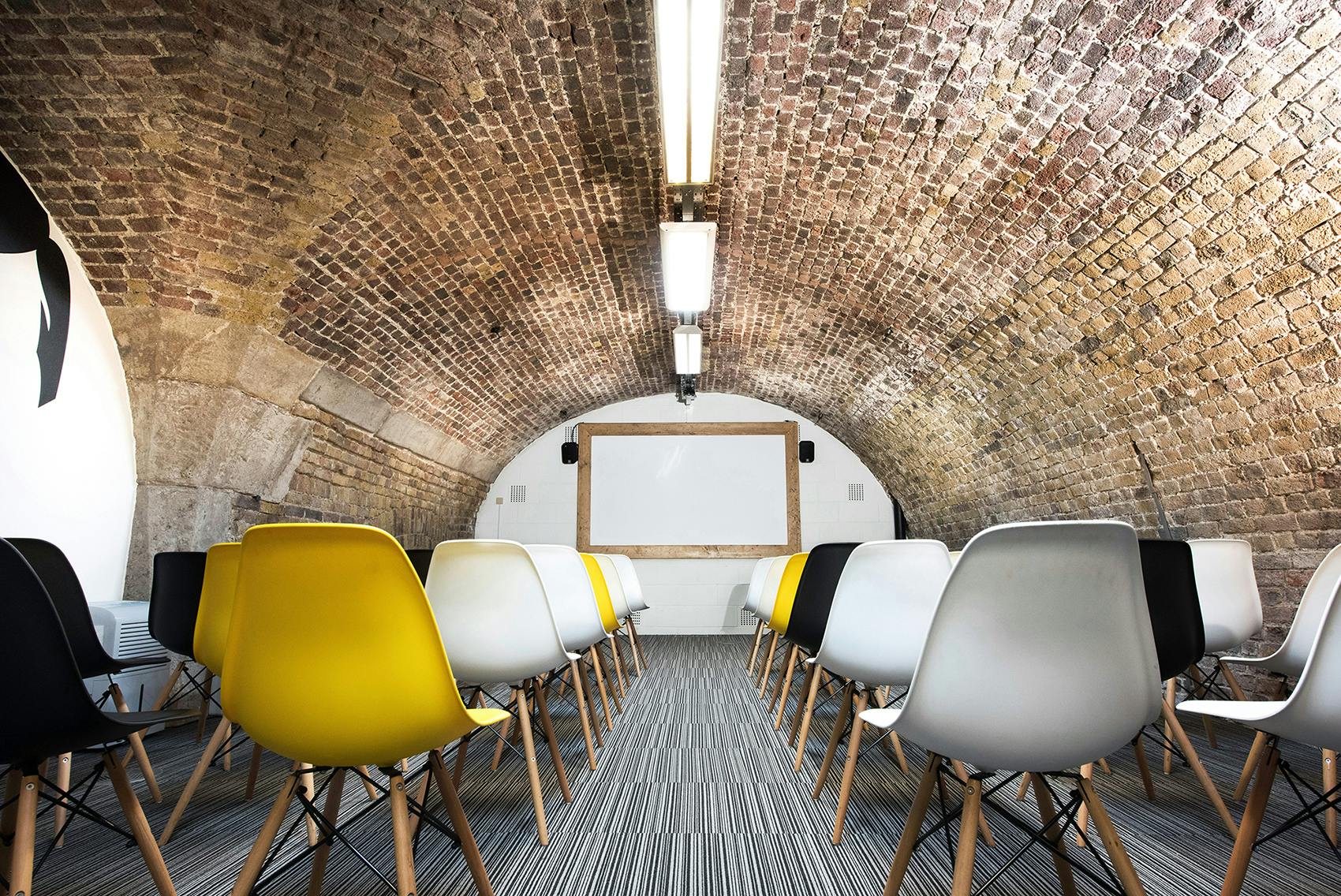 Kennedy in The Dock: arched brick ceiling, colorful chairs for workshops and presentations.