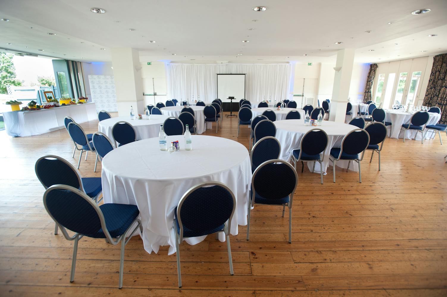 Britannia Suite event space with round tables, perfect for meetings and conferences.