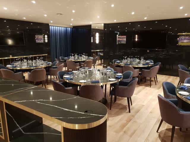 Elegant event space at Chelsea FC with round tables, ideal for corporate meetings and private dinners.